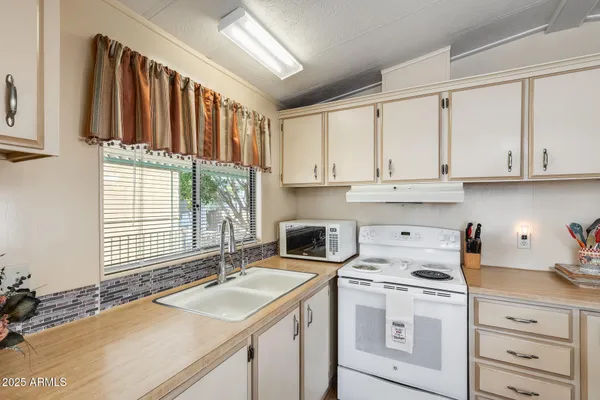 a living room with furniture ceiling fan and a rug