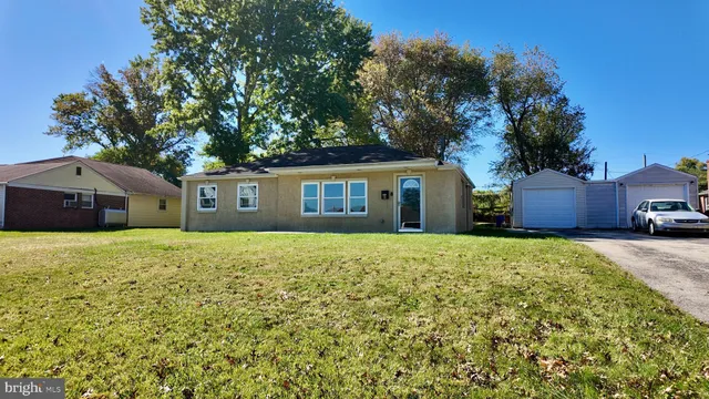a front view of house with yard and trees