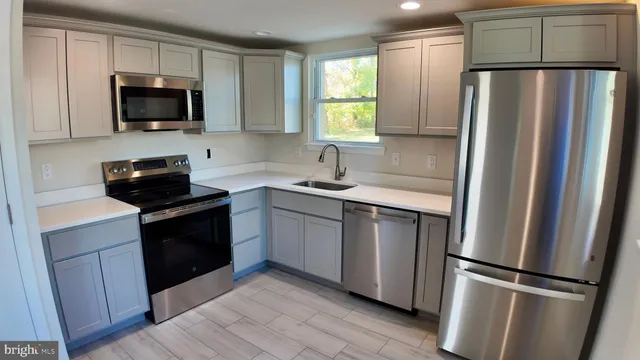 a kitchen with a refrigerator stove and microwave