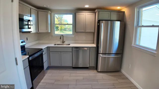 a kitchen with a refrigerator sink and stove