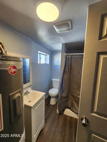 a bathroom with a sink mirror vanity and toilet