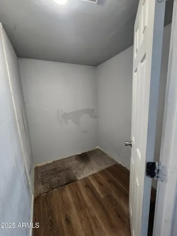 a kitchen with a refrigerator a stove top oven a sink and wooden floor