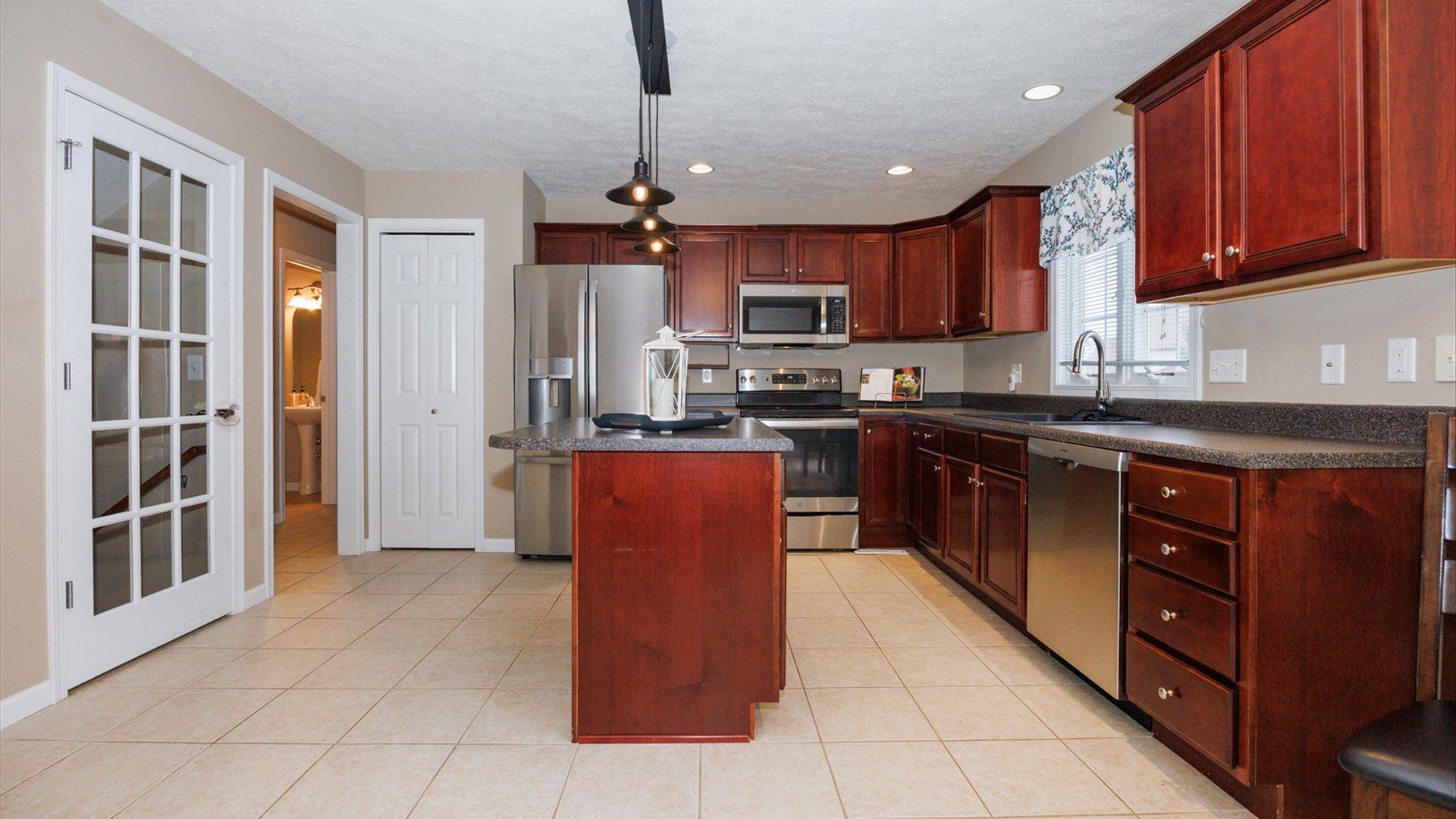 1170 Lynx Lane Normal, IL 61761 - Photo 16 of 46 a kitchen with stainless steel appliances granite countertop a stove top oven a sink dishwasher a refrigerator and a cabinets