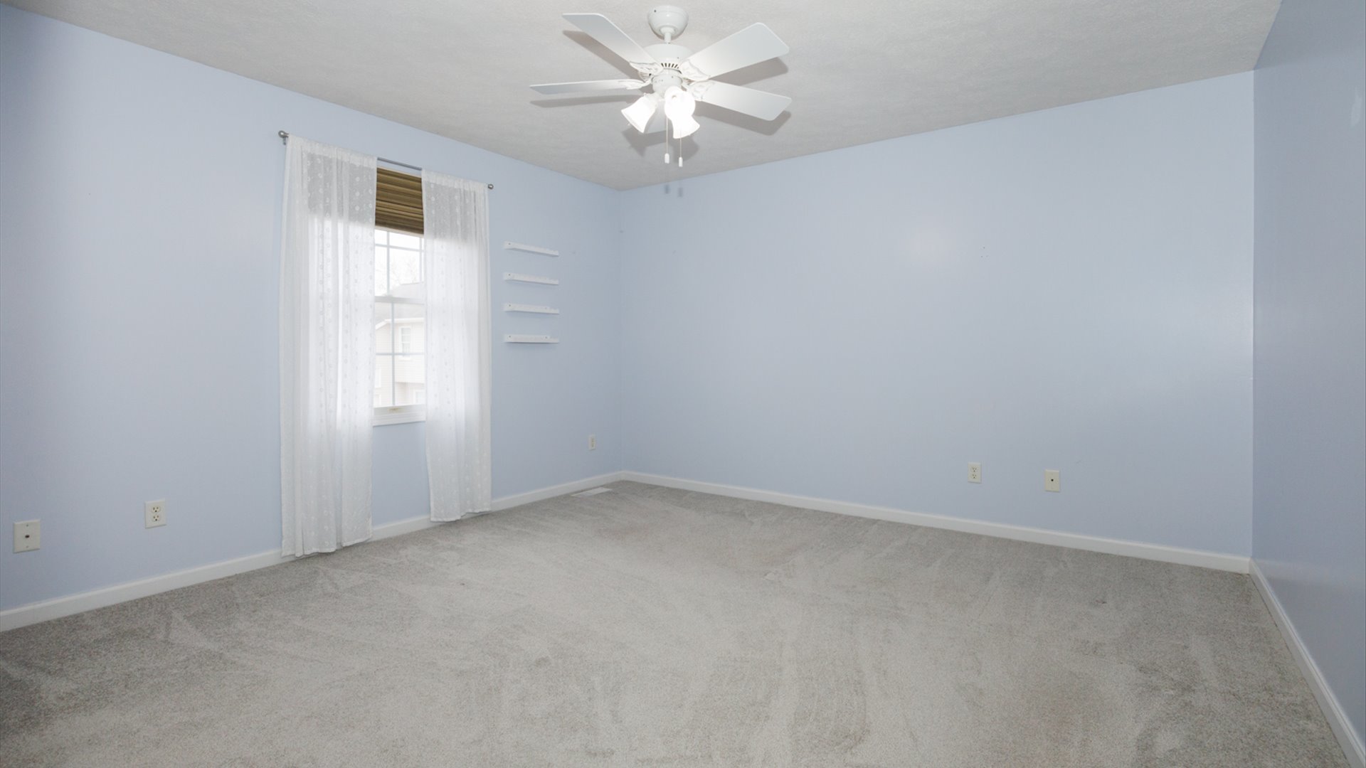 1170 Lynx Lane Normal, IL 61761 - Photo 29 of 46 an empty room with a window and a fan