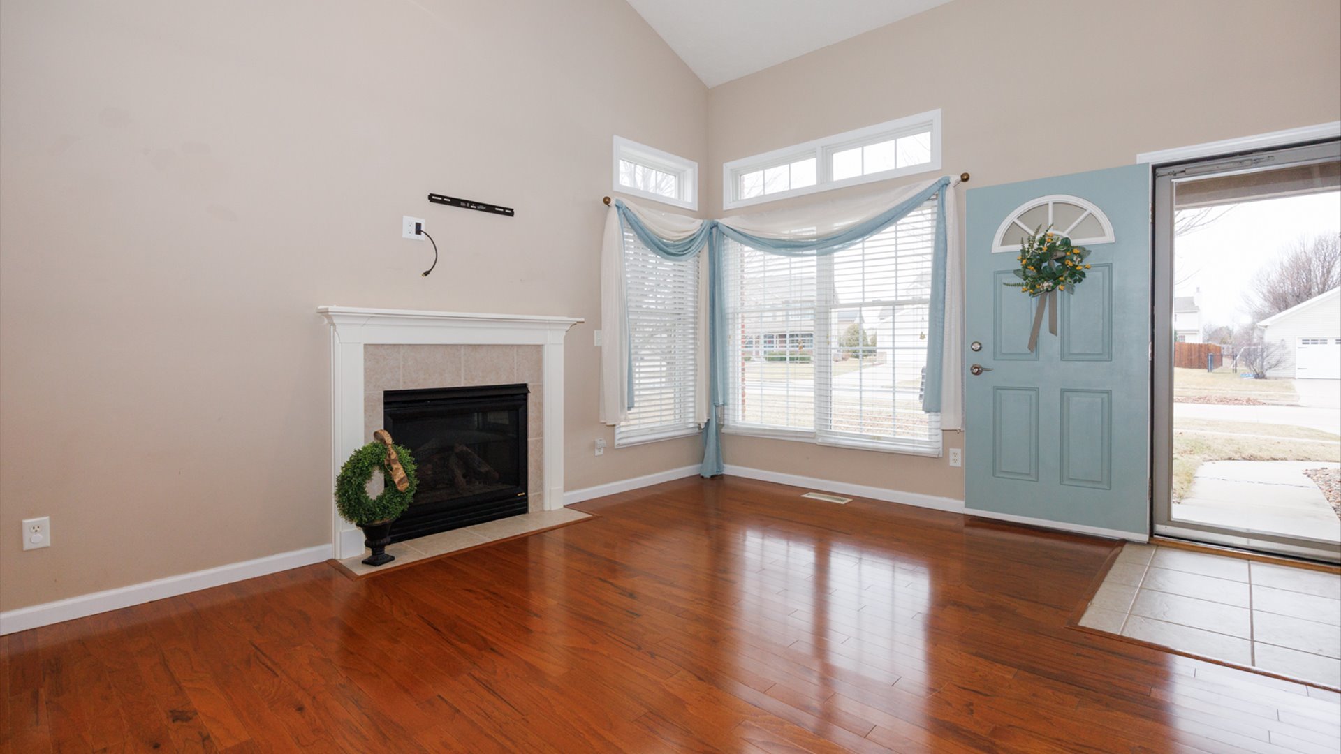 1170 Lynx Lane Normal, IL 61761 - Photo 5 of 46 a view of an empty room with wooden floor fireplace and a window