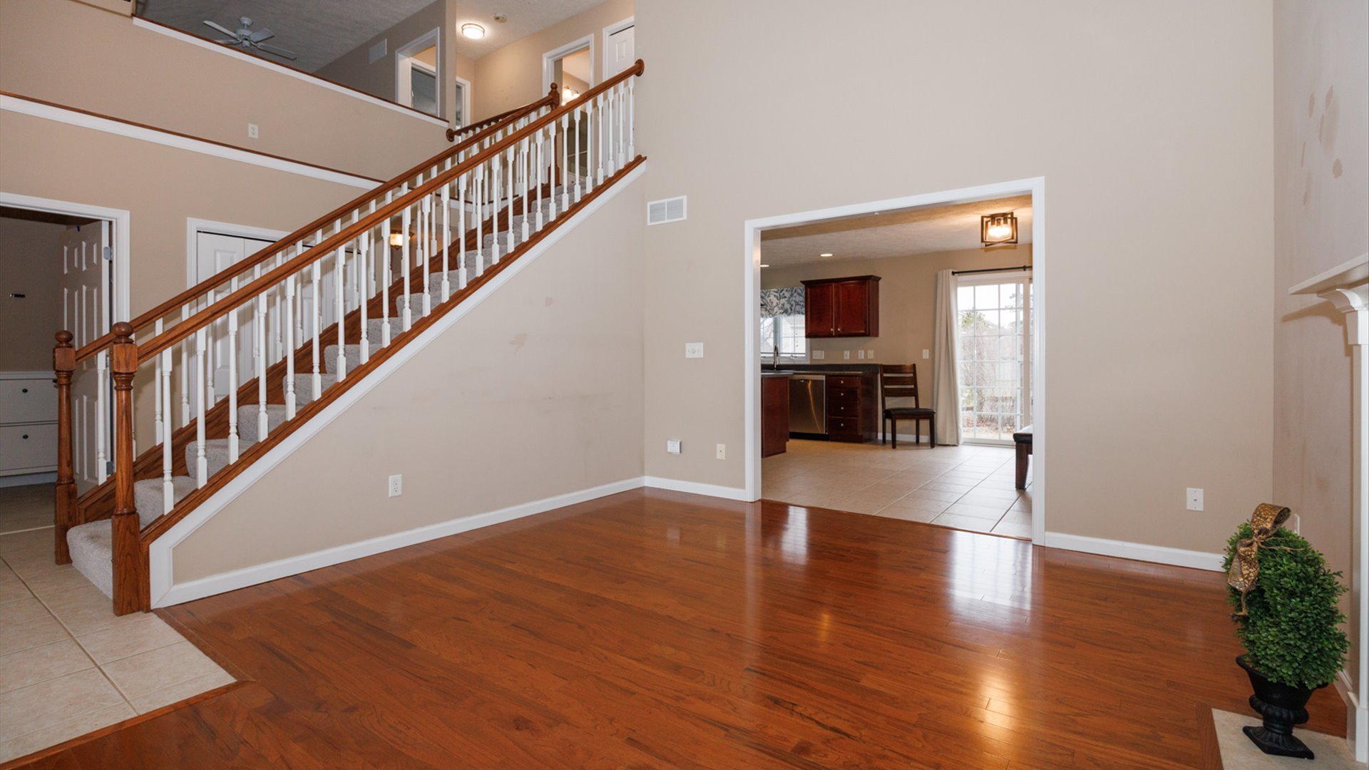 1170 Lynx Lane Normal, IL 61761 - Photo 7 of 46 a view of a hallway with wooden floor and staircase