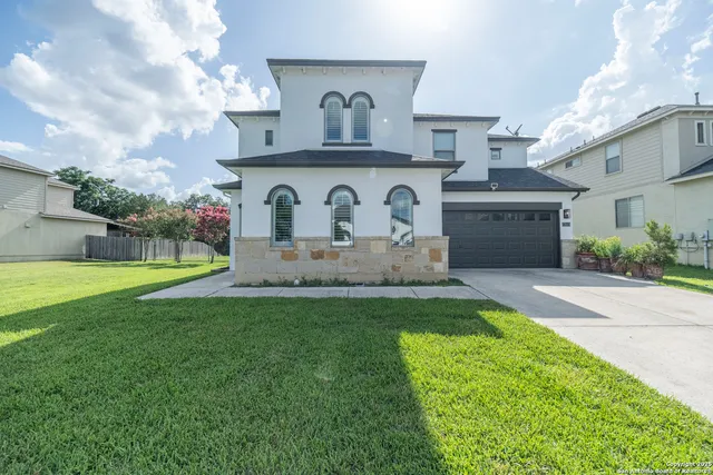a front view of house with yard and outdoor seating