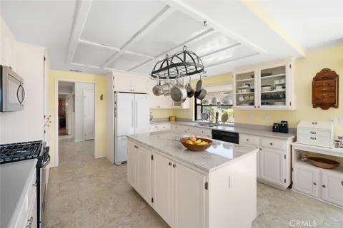 a kitchen that has a lot of cabinets in it