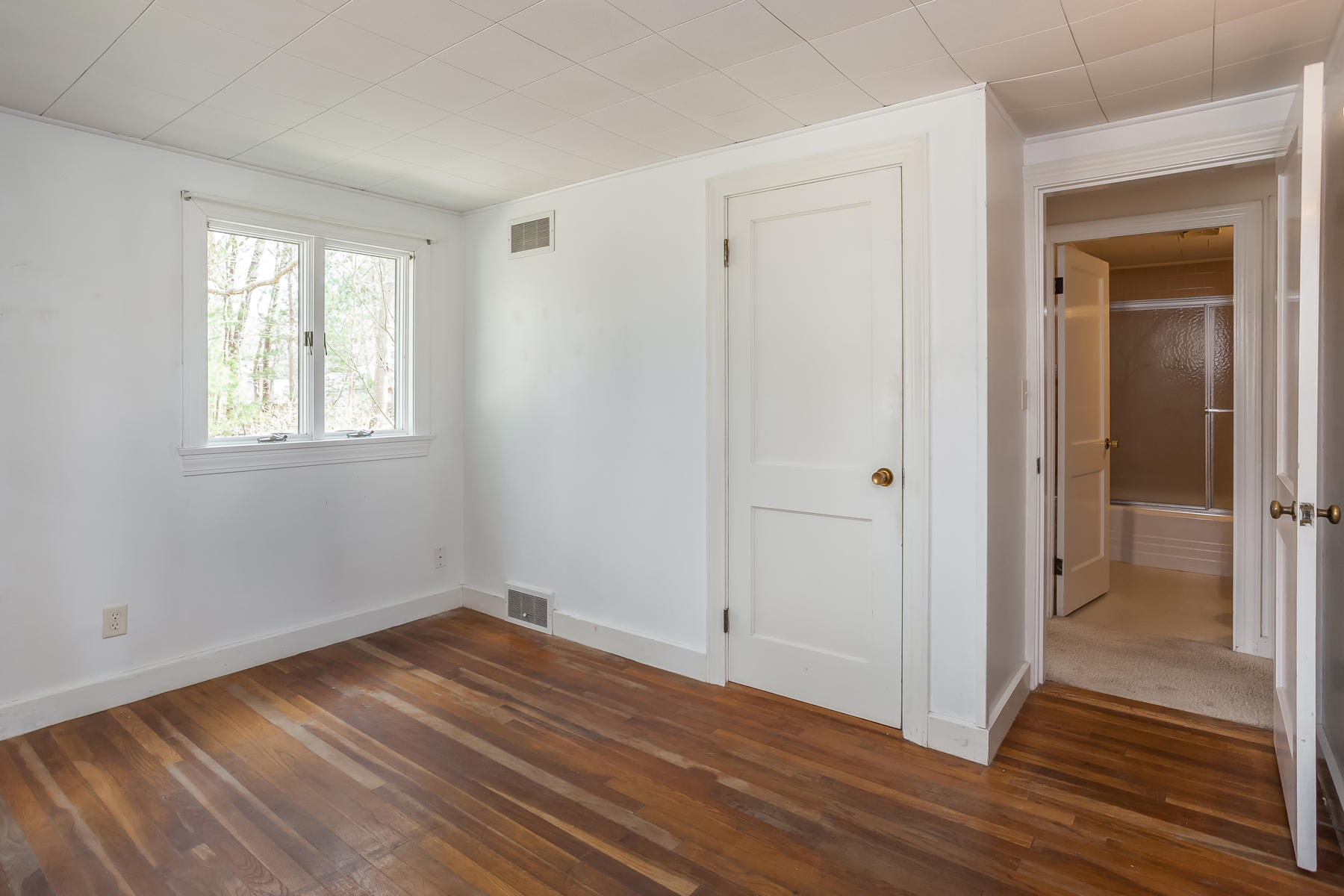 72 Eel Pond Road Bourne, MA 02532 - Photo 11 of 21 a view of an empty room with wooden floor and a window