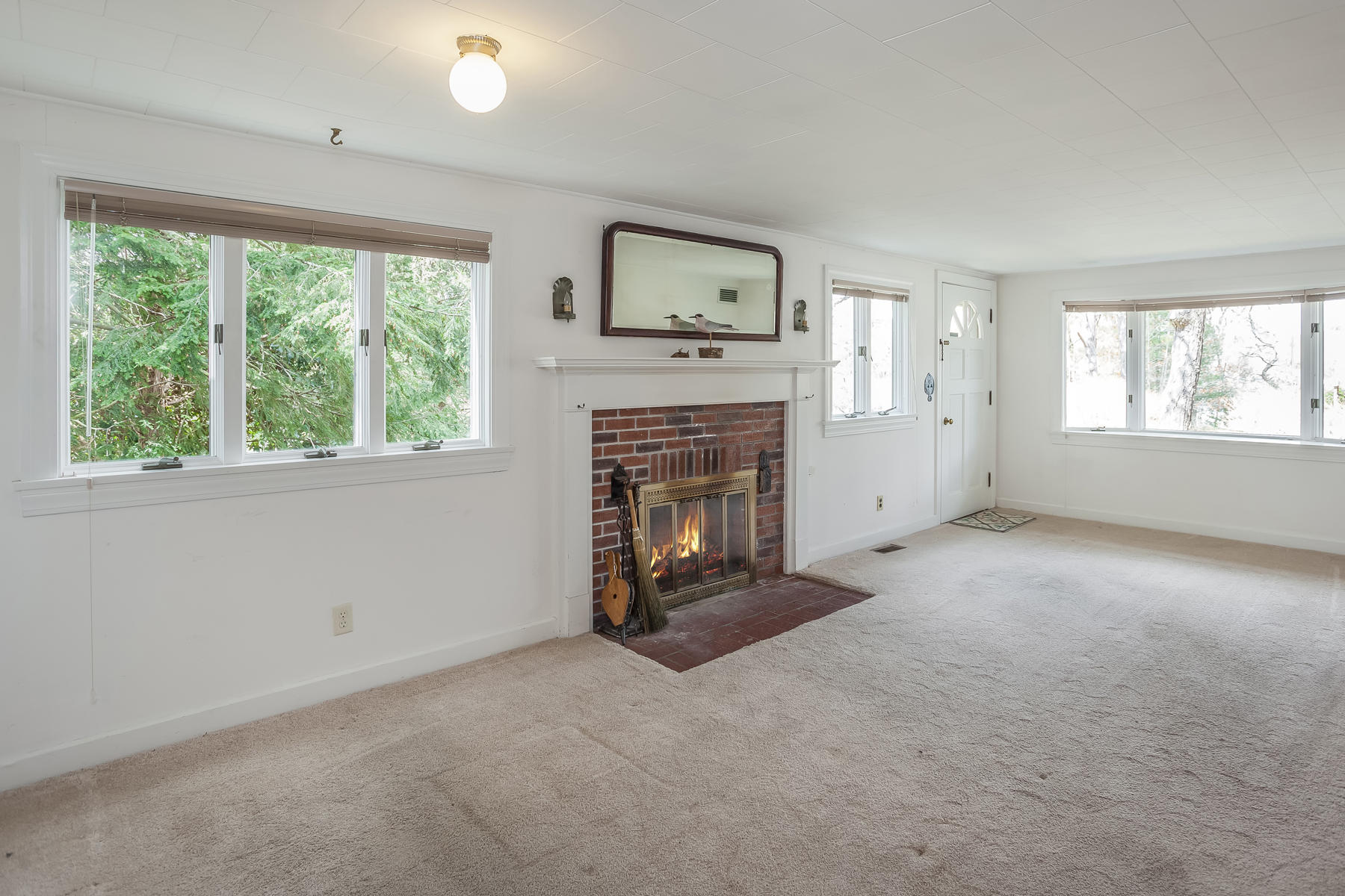 72 Eel Pond Road Bourne, MA 02532 - Photo 4 of 21 a view of an empty room with a window and fireplace