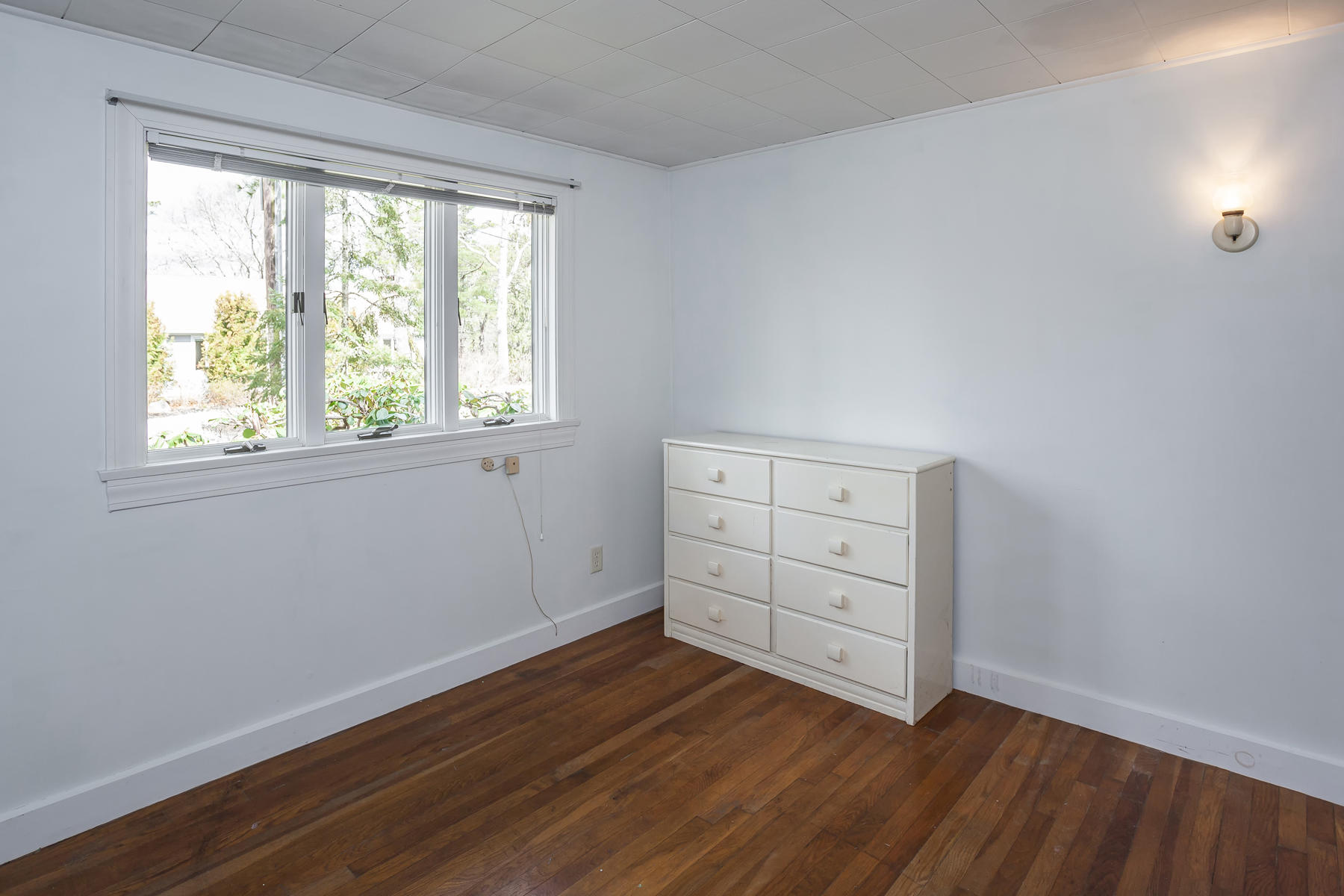 72 Eel Pond Road Bourne, MA 02532 - Photo 10 of 21 an empty room with wooden floor and window