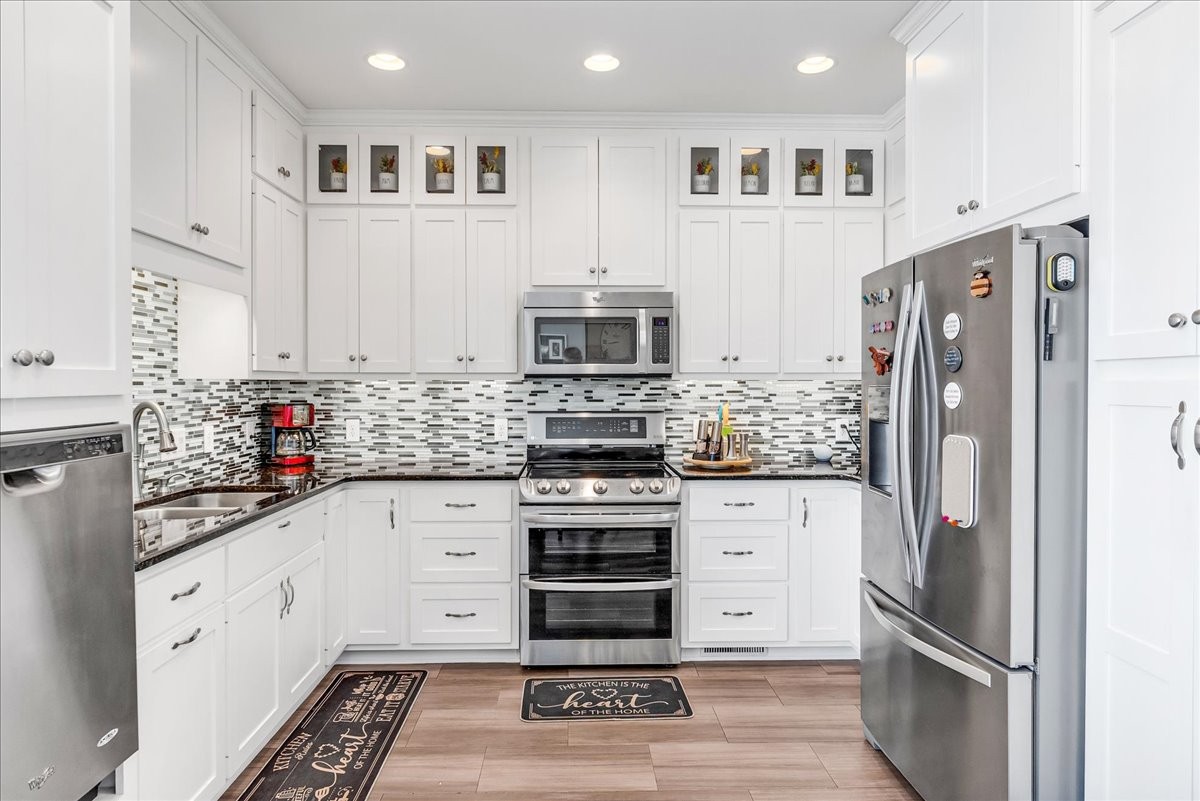 190 Stonegate Drive Smithville, TN 37166 - Photo 19 of 71 a kitchen with stainless steel appliances white cabinets and wooden floors