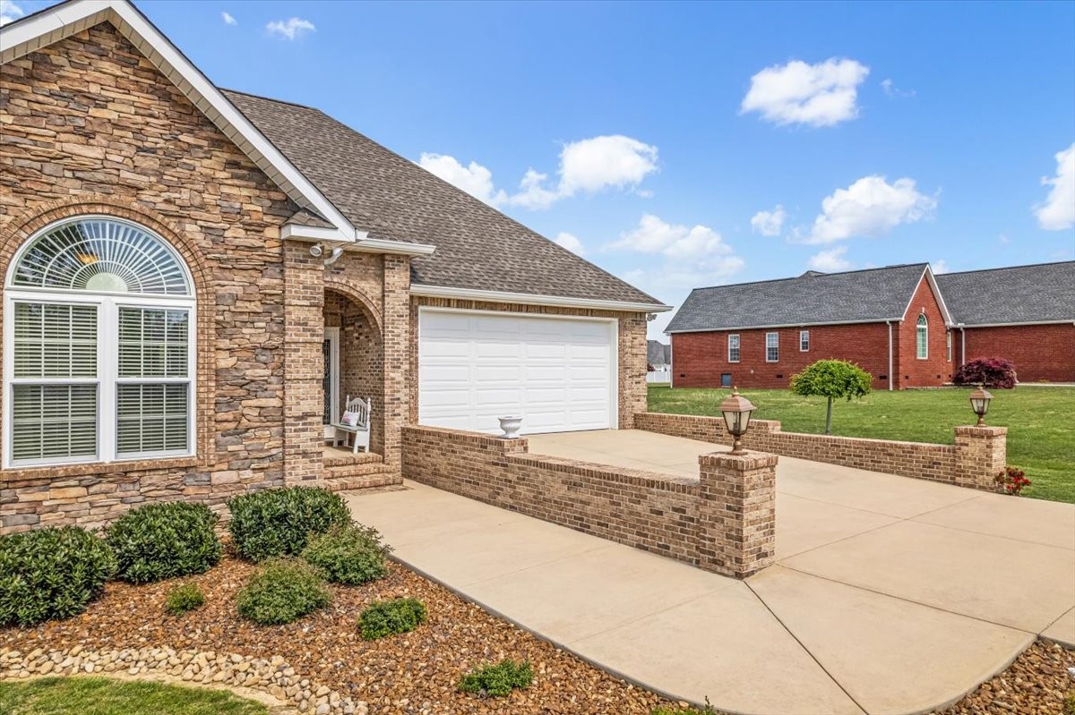 190 Stonegate Drive Smithville, TN 37166 - Photo 3 of 71 a front view of a house with a yard and garage