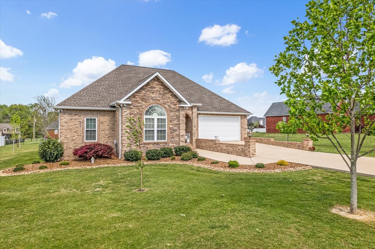 190 Stonegate Drive Smithville, TN 37166 - Photo 4 of 71 a front view of a house with a yard and garage