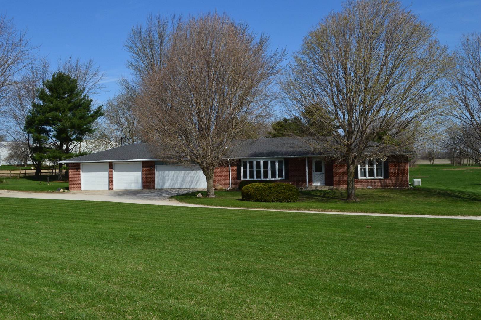 3017 Graham Road Somonauk, IL 60552 - Photo 1 of 30 a brick house with a big yard and large trees