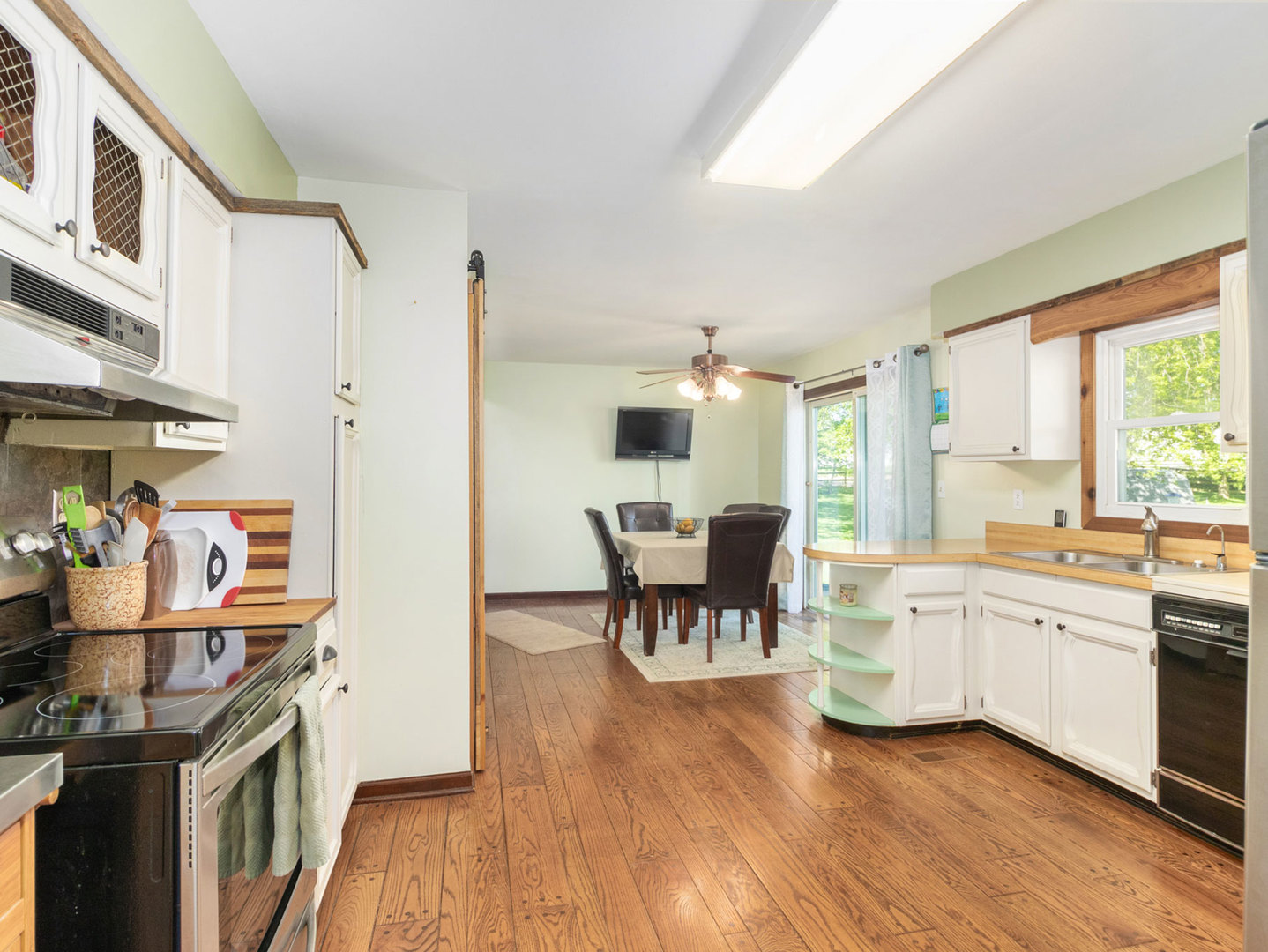 3017 Graham Road Somonauk, IL 60552 - Photo 11 of 30 a kitchen with stainless steel appliances granite countertop hardwood floor sink stove dining table and chairs