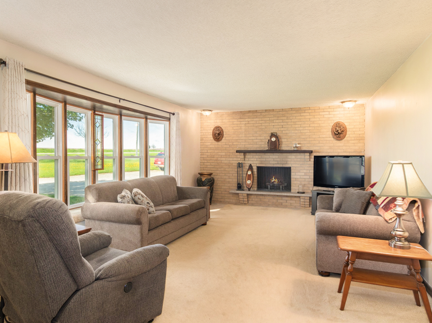 3017 Graham Road Somonauk, IL 60552 - Photo 3 of 30 a living room with furniture a large window and a fireplace