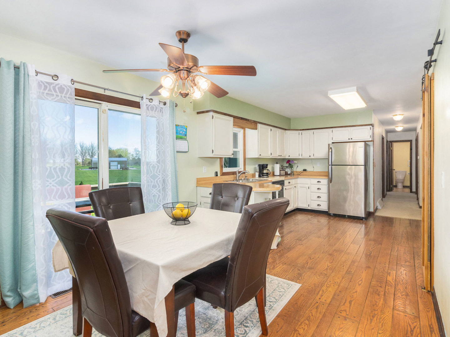 3017 Graham Road Somonauk, IL 60552 - Photo 8 of 30 a view of a dining room with furniture a chandelier and wooden floor