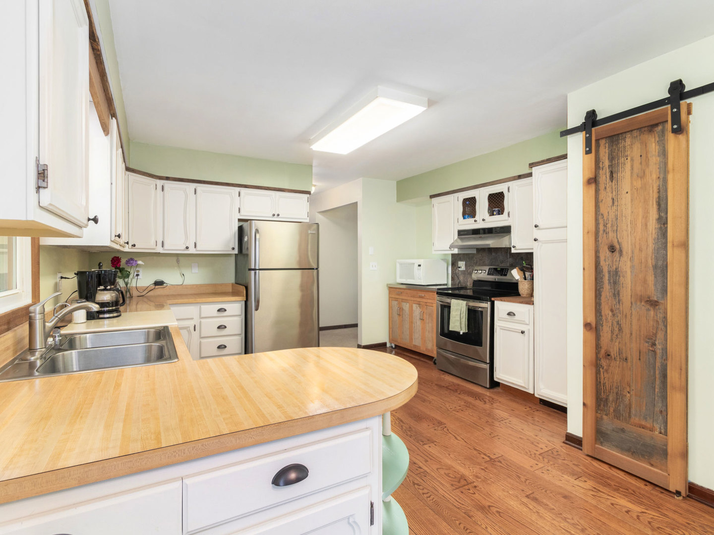 3017 Graham Road Somonauk, IL 60552 - Photo 10 of 30 a kitchen with kitchen island white cabinets and refrigerator