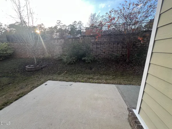 a view of a house with a door and wooden fence
