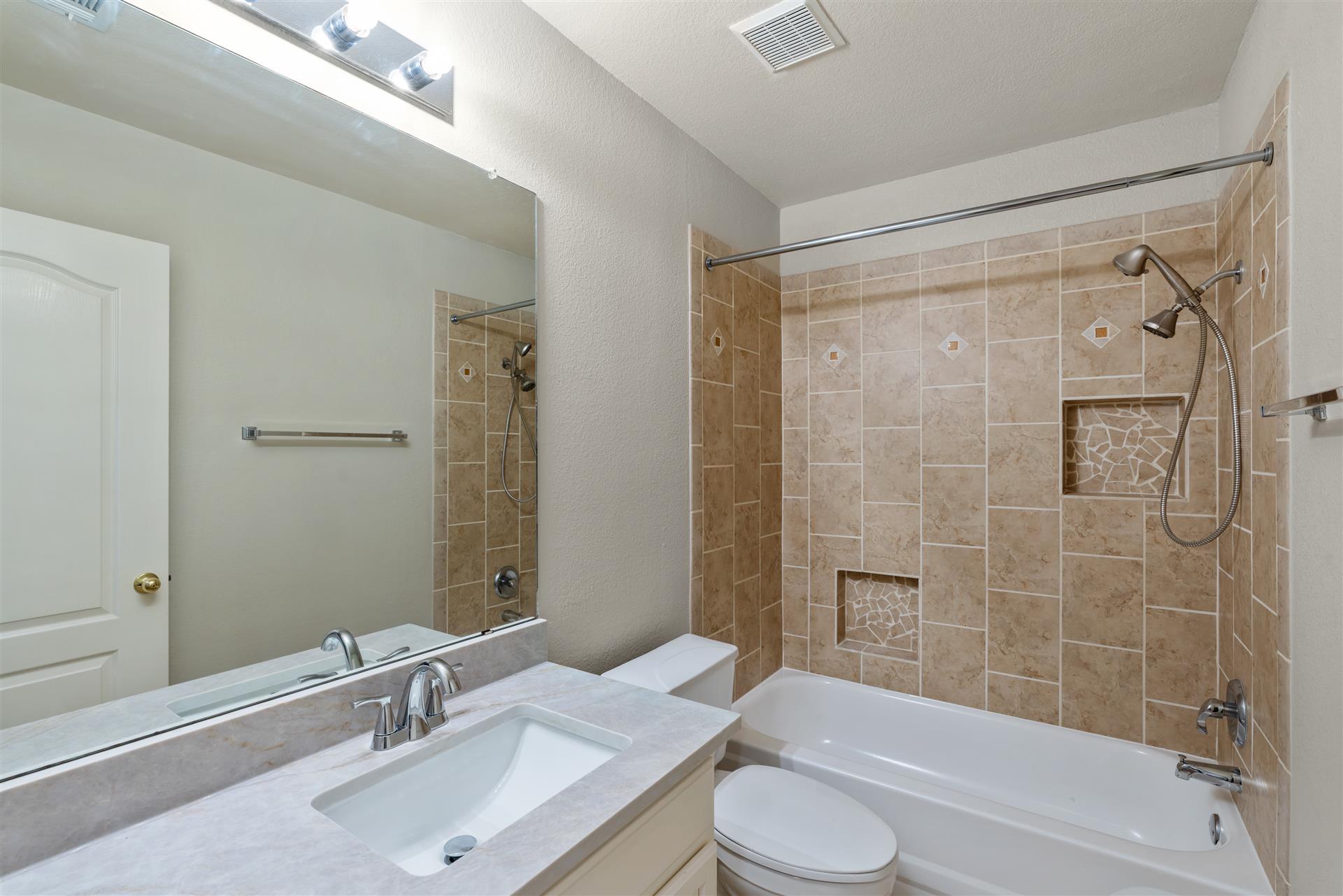 4725 Tello Path Austin, TX 78749 - Photo 25 of 34 Refined tile work adorns this well-appointed bathroom, featuring a practical tub and shower combination.