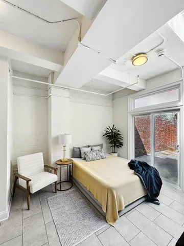 a view of walk in closet with empty racks