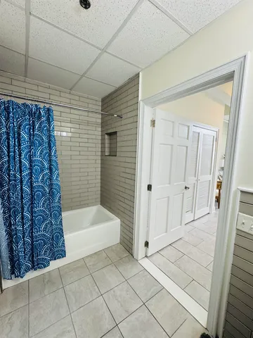 a bathroom with a mirror and a shower