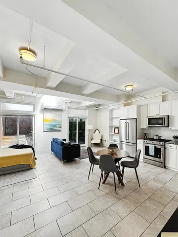 a living room with furniture and kitchen view