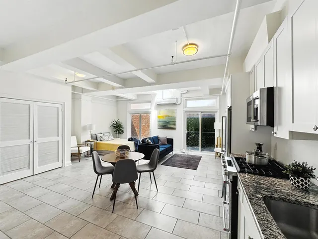 a view of a dining room with furniture and a window