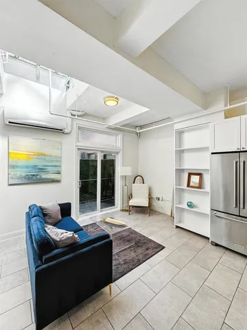 a kitchen with granite countertop a sink a stove and refrigerator