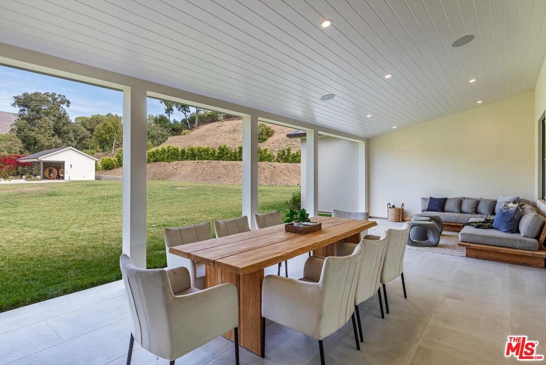 5916 Bonsall Drive Malibu, CA 90265 - Photo 15 of 20 a view of a dining room with furniture window and outside view