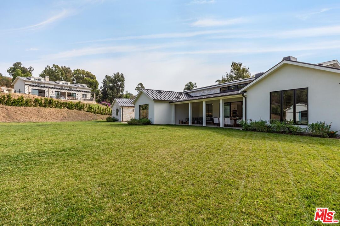 5916 Bonsall Drive Malibu, CA 90265 - Photo 17 of 20 a front view of a house with a garden