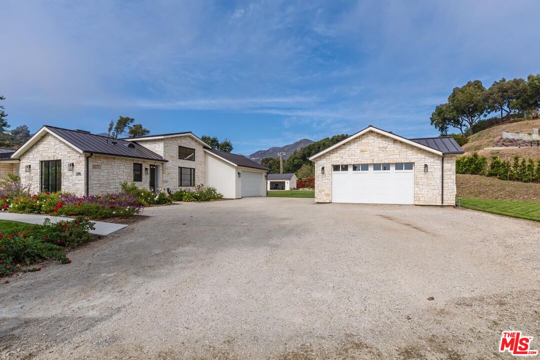 5916 Bonsall Drive Malibu, CA 90265 - Photo 2 of 20 a front view of a house with a yard and garage