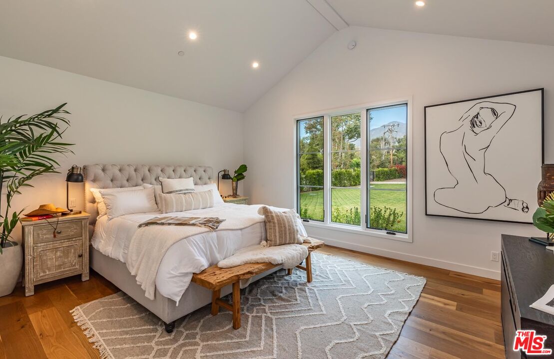 5916 Bonsall Drive Malibu, CA 90265 - Photo 8 of 20 a bedroom with a bed and a large window