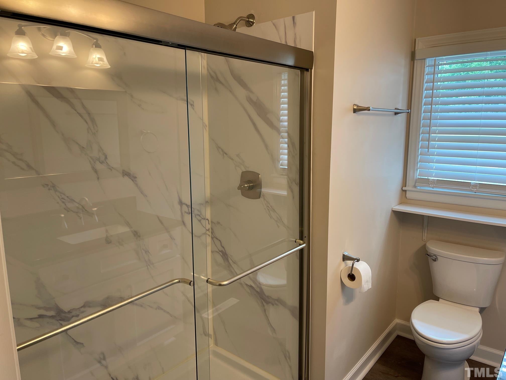 724 Mason Road Durham, NC 27712 - Photo 13 of 18 a bathroom with a toilet and a shower