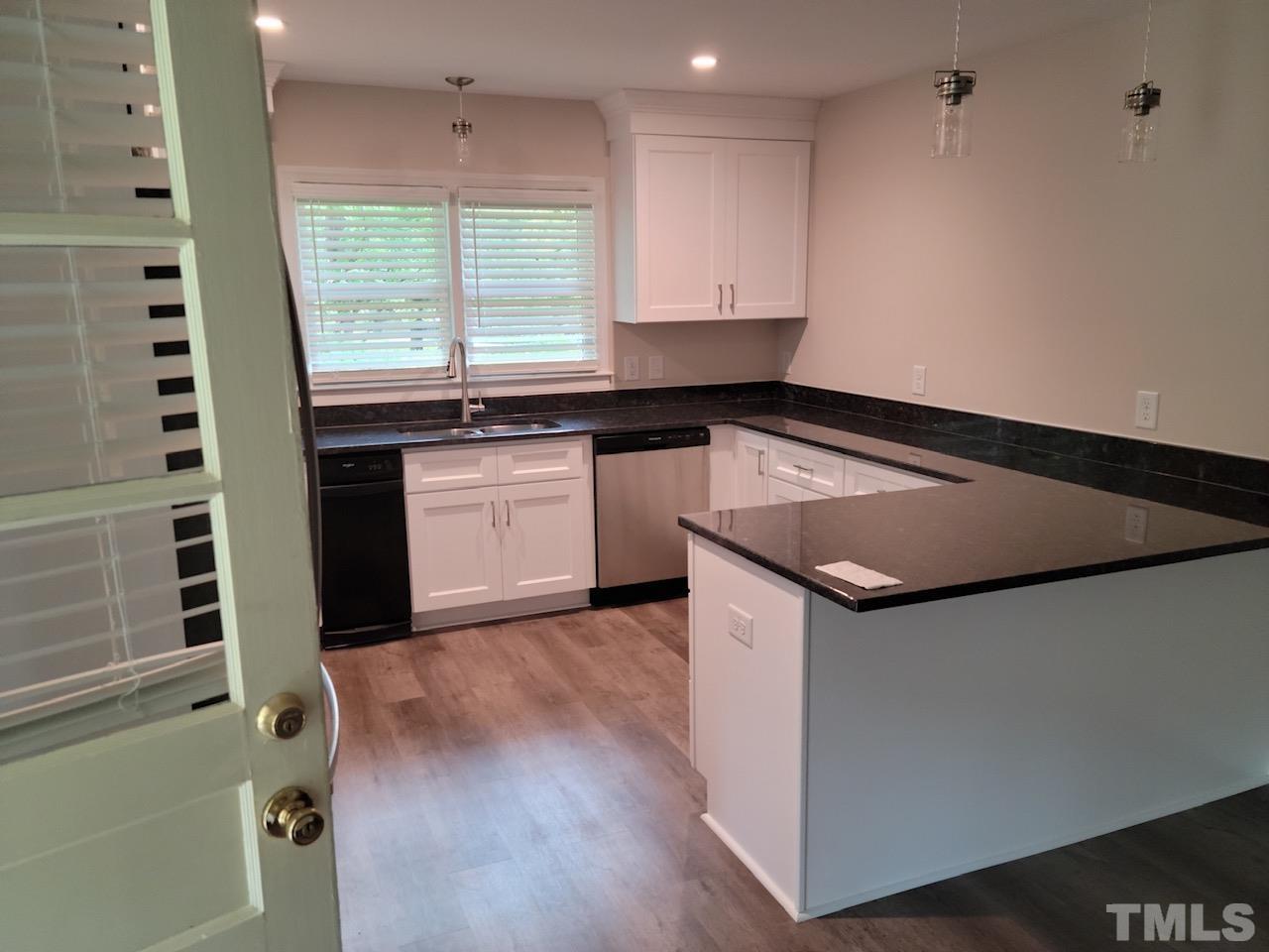 724 Mason Road Durham, NC 27712 - Photo 14 of 18 a kitchen with granite countertop a sink and a stove top oven
