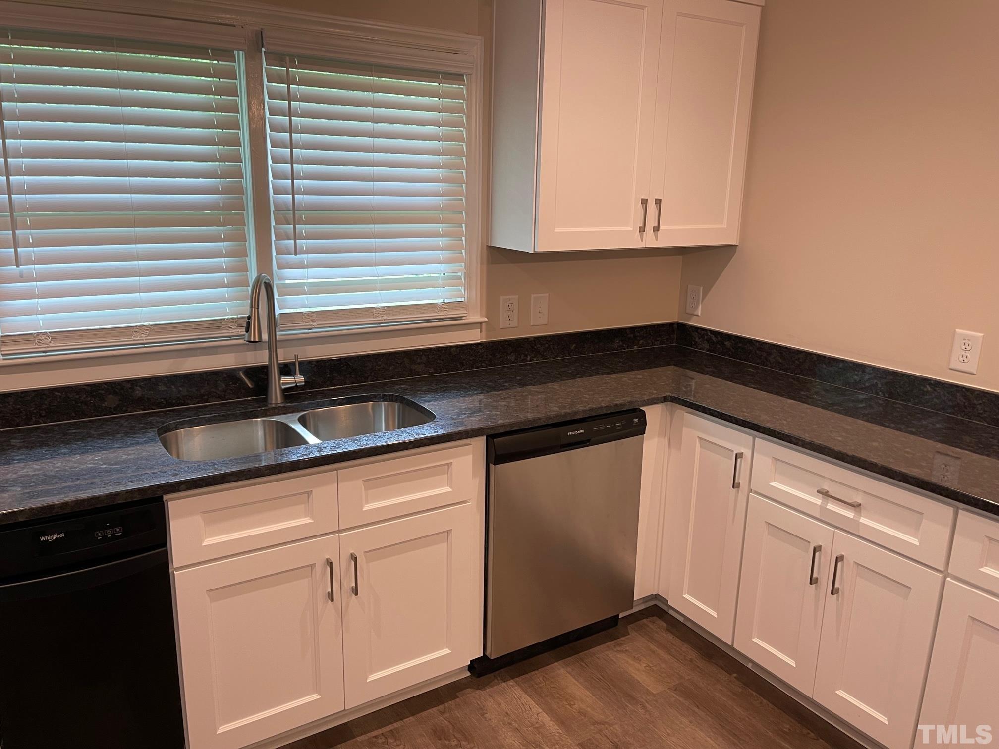 724 Mason Road Durham, NC 27712 - Photo 8 of 18 a kitchen with granite countertop white cabinets and a sink