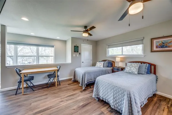 a bedroom with two beds and a window