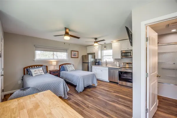 a living room with furniture and a kitchen counter space