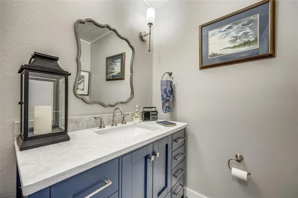 a bathroom with a sink mirror and vanity
