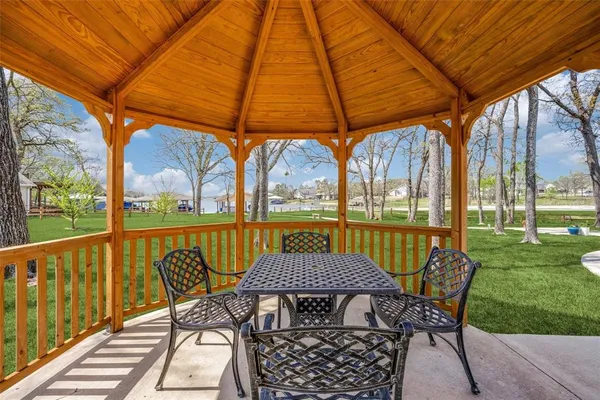 a view of chairs and table in the yard