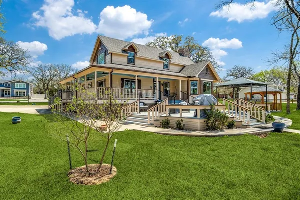 a front view of a house with garden and sitting area