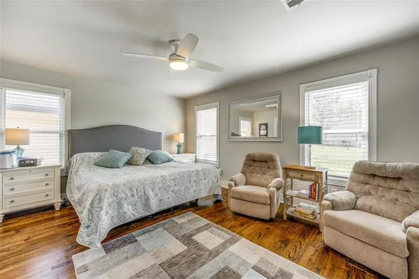 a bedroom with a bed couch and window
