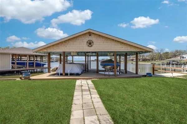 a front view of a house with swimming pool having outdoor seating