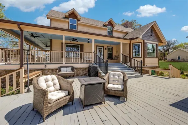 a front view of a house with barbeque oven and furniture