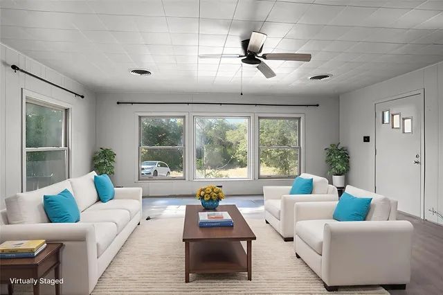 a living room with furniture and a large window