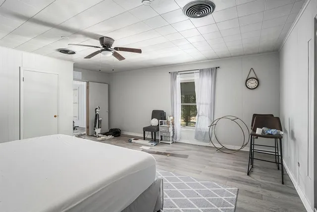 a bedroom with bed a table and chair