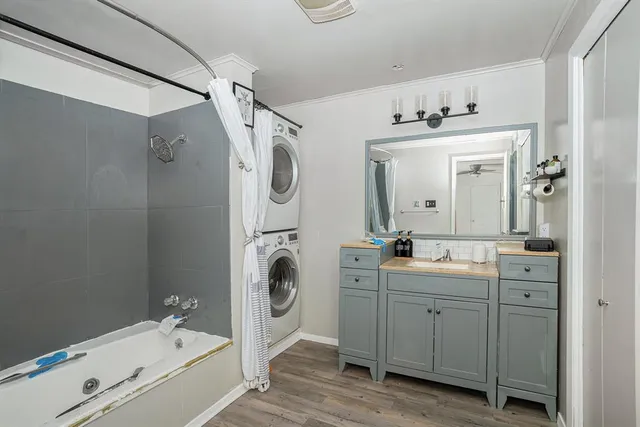 a bathroom with a sink a washer and dryer