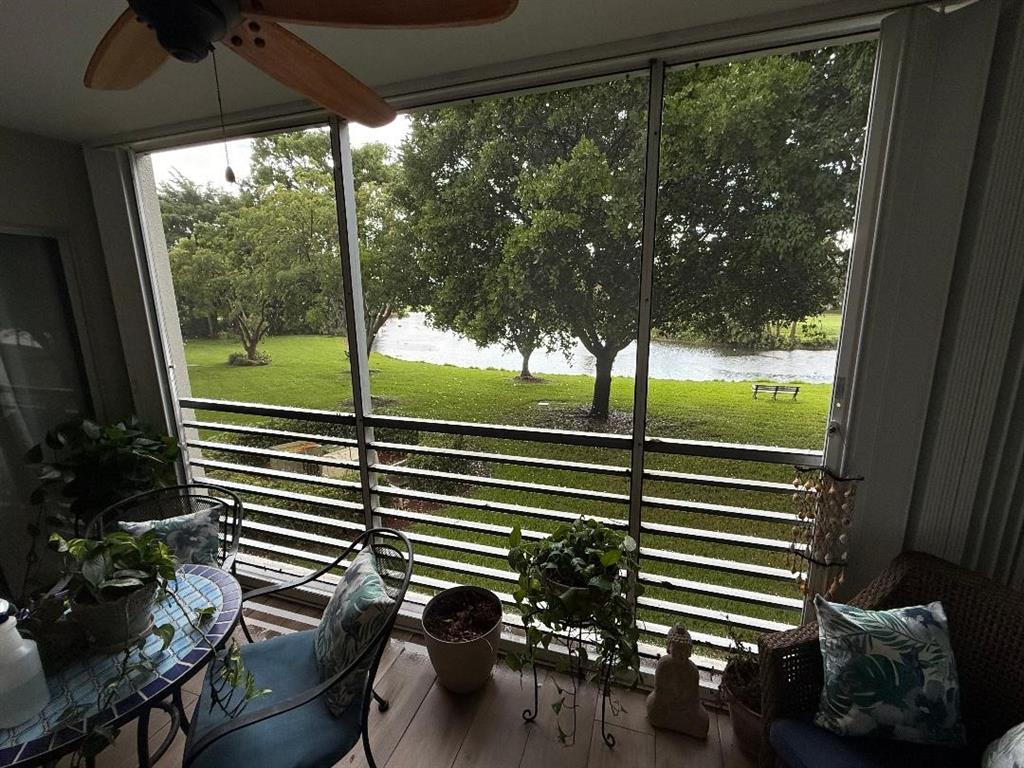 3403 Bimini Lane, Unit G2 Coconut Creek, FL 33066 - Photo 11 of 12 a view of a porch with chairs and backyard