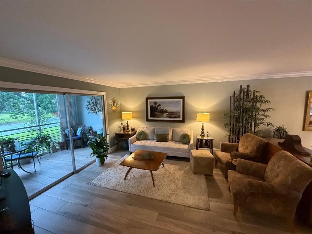 3403 Bimini Lane, Unit G2 Coconut Creek, FL 33066 - Photo 2 of 12 a living room with furniture and a wooden floor
